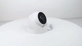 White security camera on a white surface with a light gray background