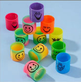 Colorful wristbands with smiley face designs on a light blue background