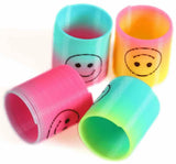 Four colorful cups with smiley face designs on a white background