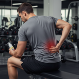 Man experiencing back pain in a gym setting