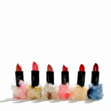 Set of six lipsticks with unique finishes on a white background