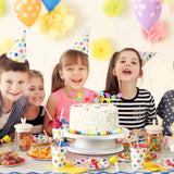 Children at a birthday party with a cake and balloons