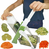 Person using a multi-blade vegetable chopper with sliced vegetables displayed.