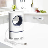 White and blue air purifier on a white surface with a blurred kitchen background