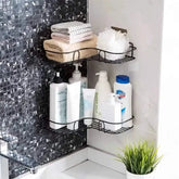 Bathroom corner with black mosaic tiles, shelves holding toiletries, and a plant.