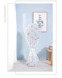 Futon cover with floral pattern on a standing futon against a light blue wall.