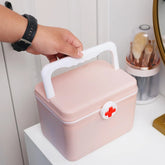 Compact portable first aid medicine box for organizing emergency medical supplies and medications.