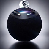 Black spherical device with a glowing interior on a dark background