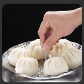 Folding stainless steel vegetable steamer basket for steaming vegetables, dumplings, and other foods.