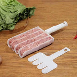 Meatloaf mold with handles on a wooden surface next to fresh greens