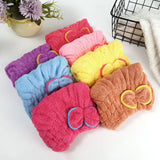 Microfiber hair drying cap with a cute bow for absorbing moisture after washing hair.