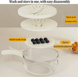 Clear glass container with white lid and handle, featuring blueberries and oranges on a light background.