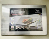 Non magnetic stainless steel cutting board in packaging on a light background