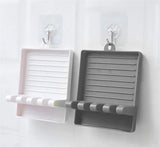 Two wall-mounted shelves, one white and one gray, with hooks on a white background.