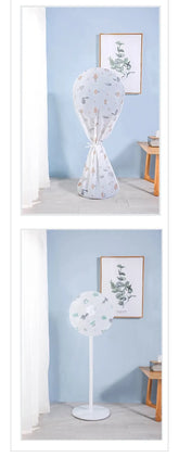 A white floor lamp with a round, semi-sheer top section featuring a delicate floral pattern, supported by a slim white stand, shown in a styled room setting with a light blue wall and framed botanical art.