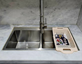 Plastic dish drainer and sink drying rack for organizing and air-drying dishes and utensils.