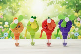 Four colorful cartoon-style fans with fruit designs on a wooden surface and floral background