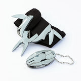Metallic shark-shaped keychain and carabiner on a white background
