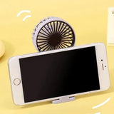 Rechargeable personal cooling fan with a lightweight handheld design for indoor and outdoor use.