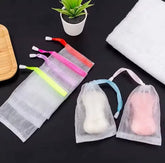 Reusable mesh soap saver drain pouch for storing soap while promoting quick drainage and drying.