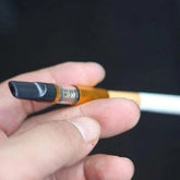 Reusable tar-reducing cigarette holder set with five holders designed to fit compatible cigarettes.