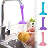 Purple faucet filter being used to wash a sponge under running water.