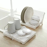 Small foldable kitchen dish drying rack for compact and efficient dish organization.