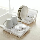 Small foldable kitchen dish drying rack for compact and efficient dish organization.