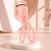 Pink handheld device on a white platform