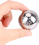A hand holding a small, shiny metallic ball with small circular cutouts, shown against a plain white background.