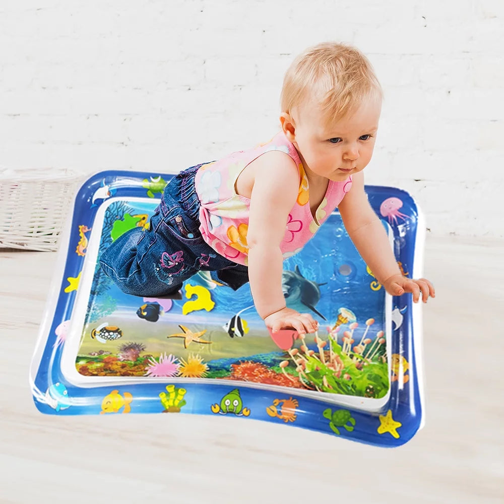Child playing on an inflatable water mat with colorful designs