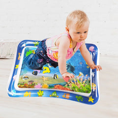 Child playing on an inflatable water mat with colorful designs
