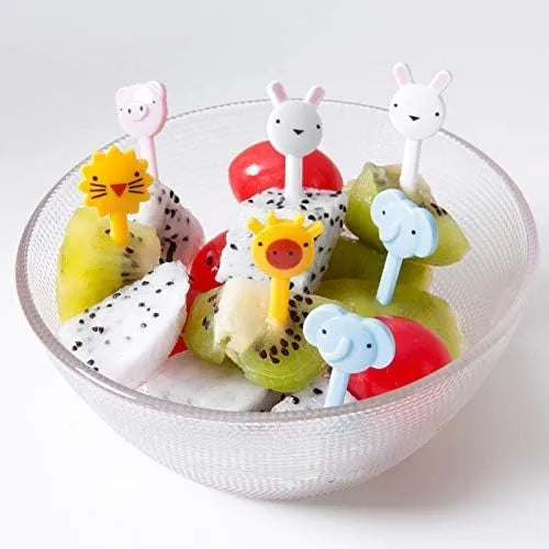 Fruit skewers with animal-shaped ends in a bowl on a white background