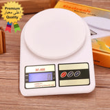 Digital kitchen scale with a visible brand name on a wooden surface