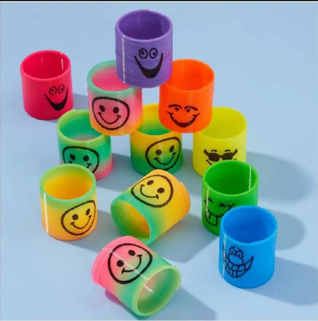 Colorful wristbands with smiley face designs on a light blue background