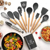 Set of kitchen utensils with wooden handles on a white surface with food items.