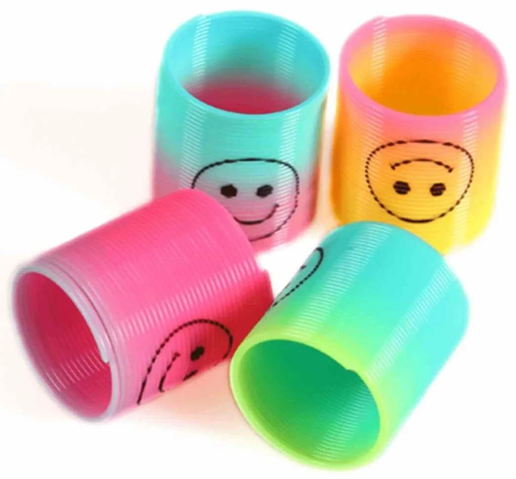 Four colorful cups with smiley face designs on a white background