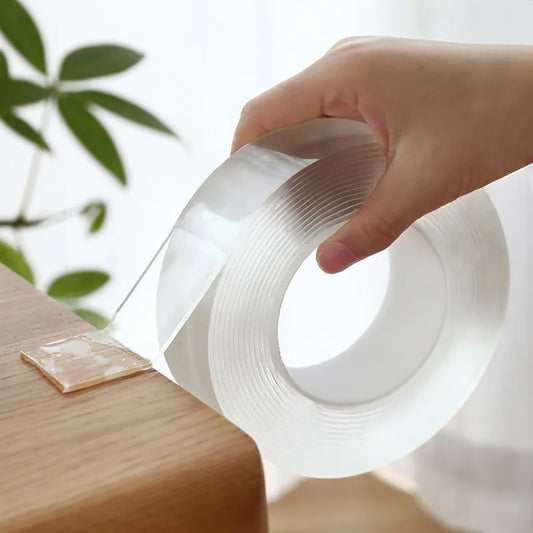 Hand holding a roll of clear tape