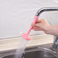 Pink faucet extension with water flowing from a kitchen sink