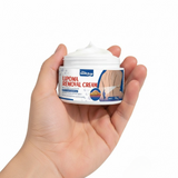Hand holding a jar of lipoma removal cream against a white background