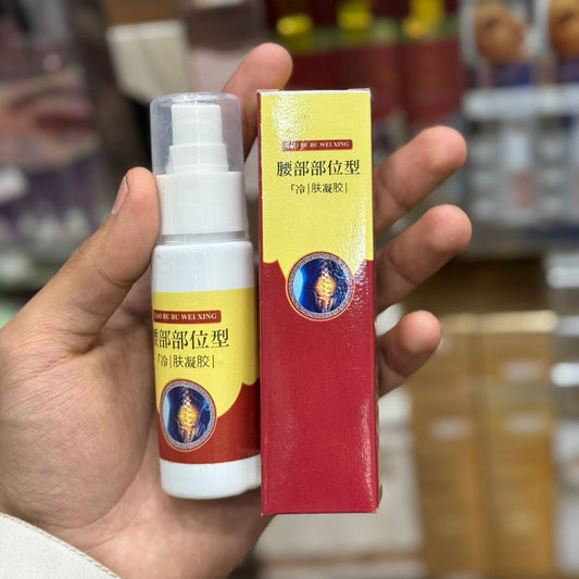 Hand holding a spray bottle and its packaging with a blurred background