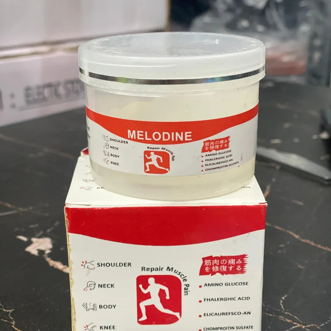 Melodine container and box on a dark surface