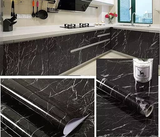Black marble texture vinyl wrap applied to a kitchen countertop.