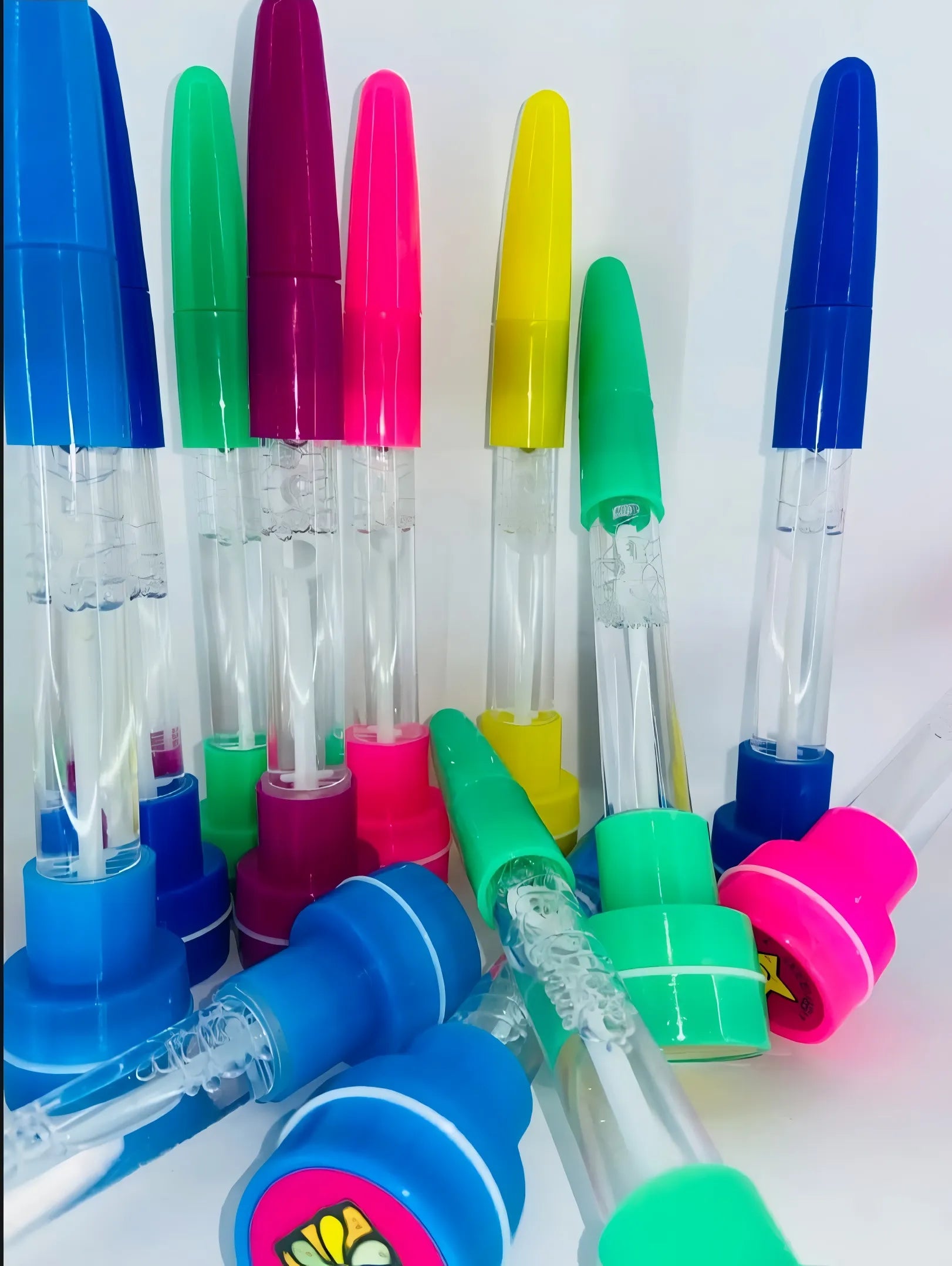 Colorful water bottles with various colored caps on a white background