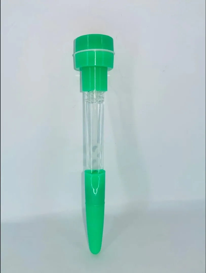 A clear plastic test strip tube with bright green plastic end caps and a clear central chamber, standing upright against a plain light gray background.