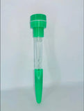 A clear plastic test strip tube with bright green plastic end caps and a clear central chamber, standing upright against a plain light gray background.