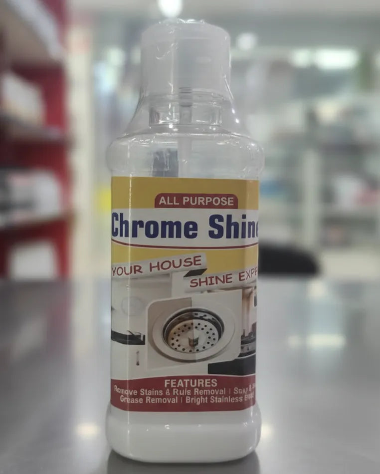 Bottle of chrome shine cleaner with a label on a reflective surface.