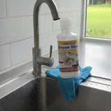 Chrome Shine cleaner bottle on a blue towel over a sink with a window in the background