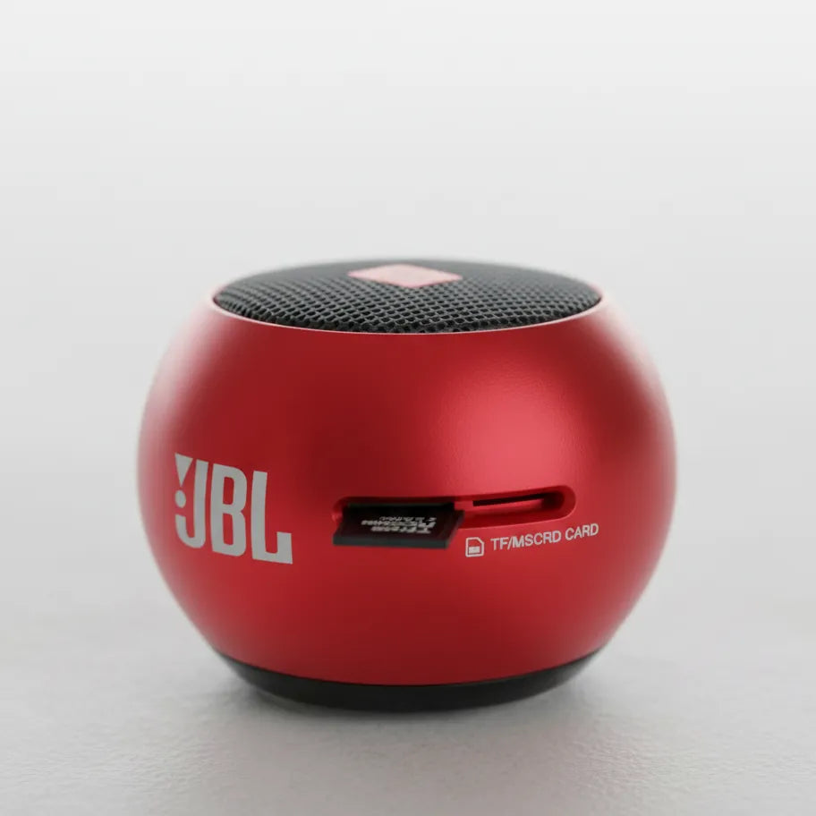 Red JBL speaker on a light gray background