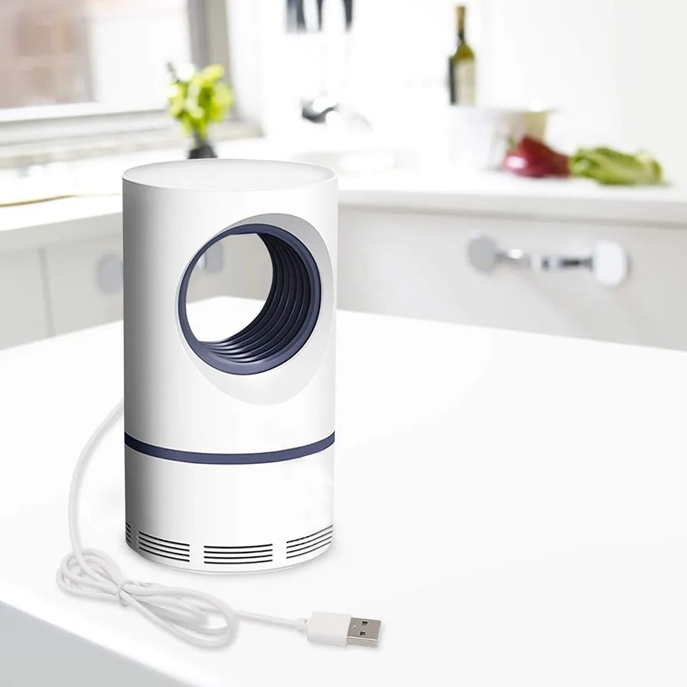 White and blue air purifier on a white surface with a blurred kitchen background